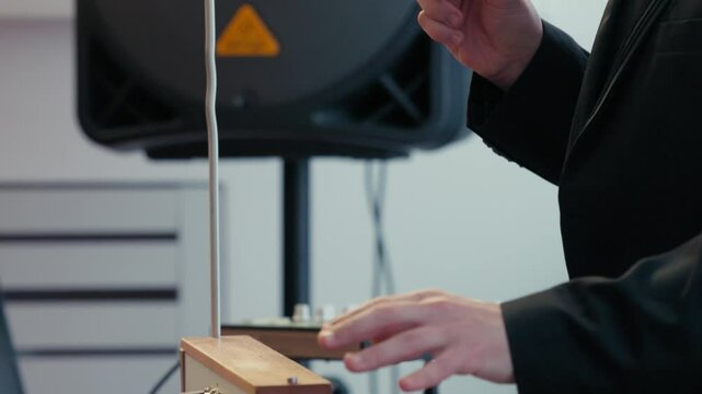 Playing the theremin. The theremin, etherphone, thereminophone or termenvox, thereminvox, is an electronic musical instrument controlled without physical contact by the performer. Patented in 1928