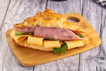 Fresh croissant with ham and cheese