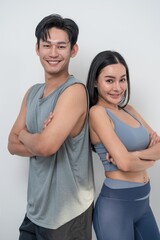 Fototapeta premium Fitness enthusiasts pose together in workout attire, showcasing confidence and camaraderie