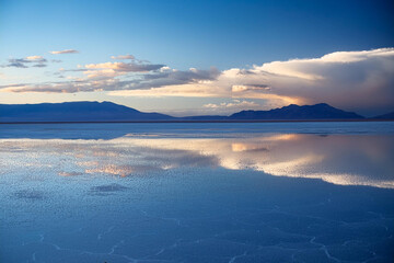 Fototapeta premium Dramatic Reflective Landscape with Moody Sky and Mountains
