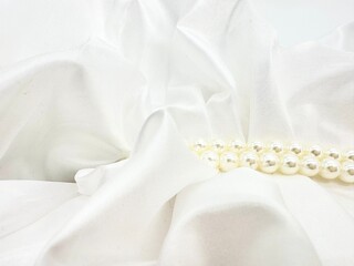 Elegant white pearls scattered on a pristine white background.