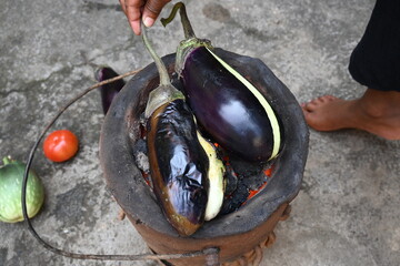 Roasting eggplant or Brinjal on a coal stove. By Roasting and Mashed it, a famous dish Baingan Ka Bharta is made. It is liked in almost all regions of India.
