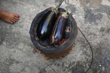 Roasting eggplant or Brinjal on a coal stove. By Roasting and Mashed it, a famous dish Baingan Ka...