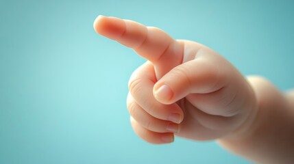 Baby hand pointing, blue background