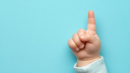 Baby hand pointing up, blue background