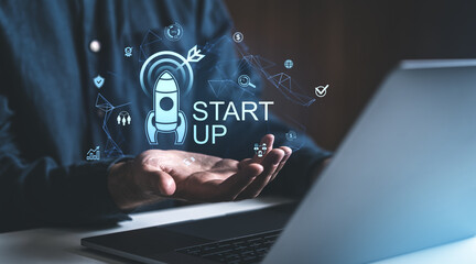 Startup business concept with digital rocket hologram.