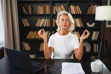 Yoga mindfulness meditation No stress keep calm. Middle aged woman practicing yoga at office. Woman...