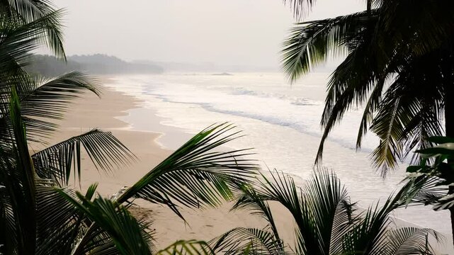 View of misty morning over the West African coast with an empty beautiful beach in Ghana Axim.