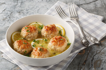 Chicken piccata meatballs are made with juicy chicken minced and a buttery sauce with capers and lemon juice closeup on the plate on the table. Horizontal