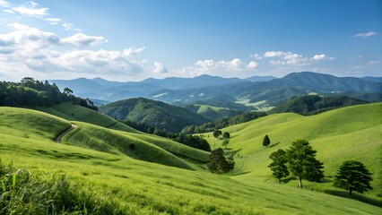 Naklejka premium Rolling green hills and mountains under a blue sky