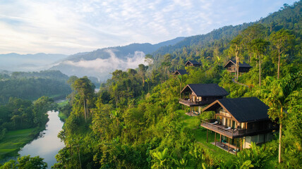 Fototapeta premium Lush rainforest eco tourism with scenic cabins by river in mountains