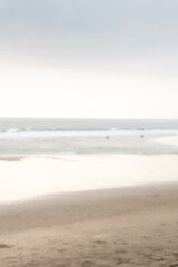 Blurry background of cloudy beach at sunset