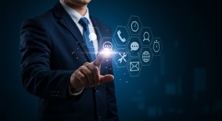 Obraz premium Businessman activating a futuristic interface with communication icons interface