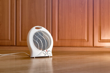Modern electric fan heater on the floor in the room, space for text. Portable heater. Autumn concept and technology, air heater in the house.	