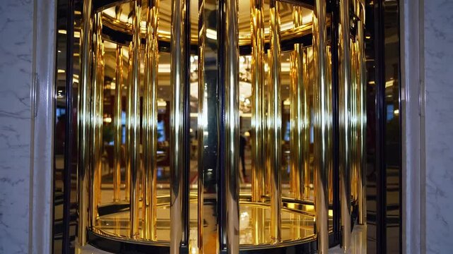 Luxury hotel entrance with spinning golden revolving door, gleaming marble flooring, sparkling crystal chandelier, sophisticated seating highlighting high end hospitality elegance