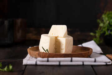 Caciotta Tuscan cacciola italian fresh delicate cheese on olive wooden plate.