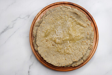 Roti and Sabzi. Indian vegetarian Thali includes bhindi fry, yellow daal tadka, cucumber raita, and jawari or Jowar bhakri. Indian food is served in a plate or thali. Copy Space. healthy Veg Thali.