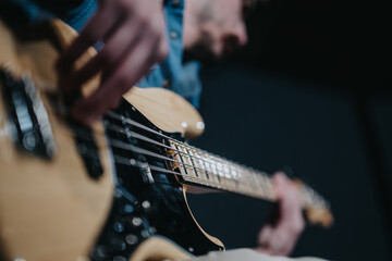 Fototapeta premium A person skillfully playing an electric guitar, captured with a dynamic and artistic focus.