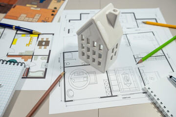 A detailed model house is elegantly positioned on top of an architects house plan design