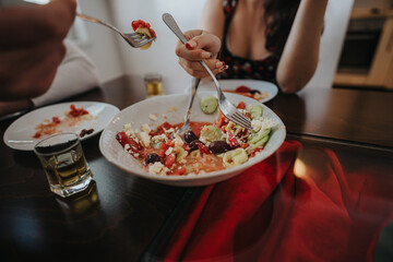 A close-up of friends sharing a delicious Mediterranean salad at a table, creating a warm and inviting dining atmosphere with drinks. The image conveys togetherness and enjoyment of good food.