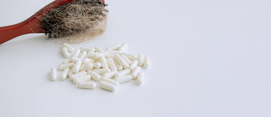 hair brush with hair and vitamins. hair loss