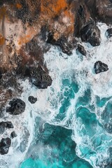 Obraz premium Aerial view of ocean waves crashing against rocky coastline with turquoise water and sandy beach, coastal landscape, nature scenery, travel destination, relaxation.
