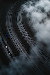 Car tire tracks on a wet road creating smoke with a dramatic twist in the asphalt, conveying speed, performance, and adrenaline in motorsports racing.