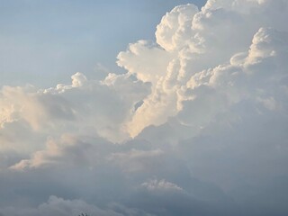 Beautiful fluffy clouds in the bright blue sky