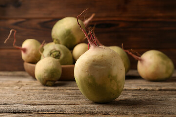 Whole fresh turnips on wooden table, closeup