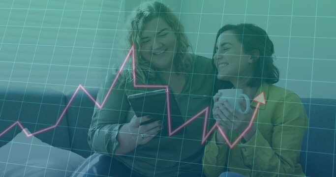 Image of data processing and diagrams over caucasian female couple using tablet at home