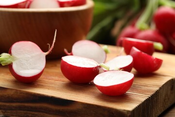 Fresh cut radishes on wooden board, closeup