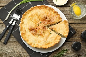 Delicious fresh homemade pie served on wooden table, flat lay