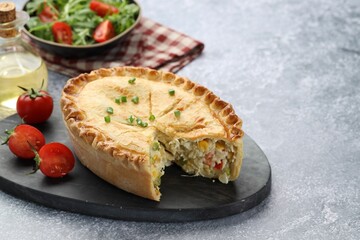 Delicious fresh homemade pie and tomatoes on gray textured table, closeup. Space for text