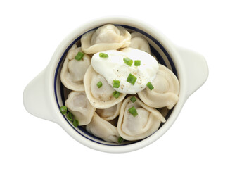 Delicious dumplings (pelmeni) with green onion and sour cream in bowl isolated on white, top view