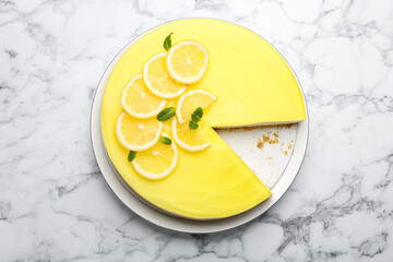 Tasty lemon cheesecake with mint on white marble table, top view