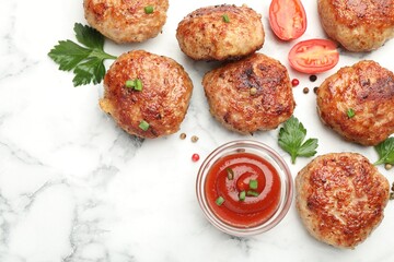Delicious patties with sauce, cherry tomatoes, peppercorns and parsley on white marble table, flat lay. Space for text