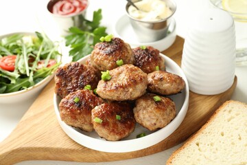 Delicious patties with green served on table, closeup