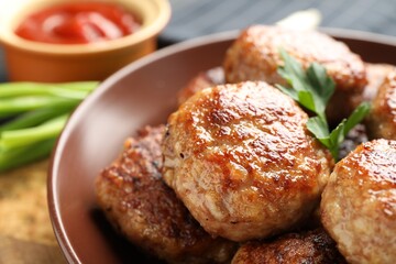 Delicious patties with parsley on table, closeup