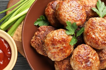 Delicious patties and spices on black textured table, flat lay