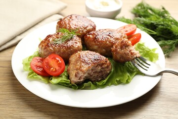 Delicious patties served on wooden table, closeup