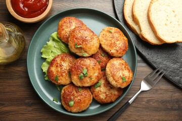Delicious patties served on wooden table, flat lay
