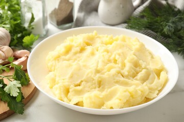 Delicious mashed potato served on white table, closeup