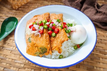 Grilled fish with curry paste with  boiled egg and rice topped with thai chili fish sauce,  thai called Ho mok	