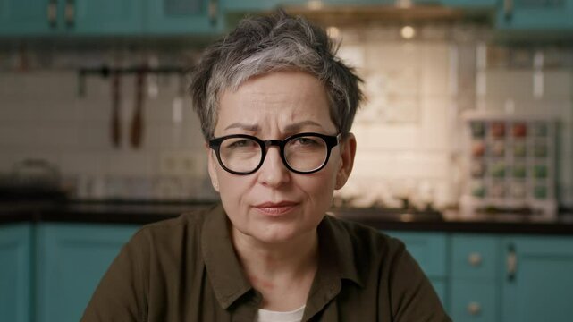 Mature Woman in Eyeglasses Making WOW Expression Looking at Camera