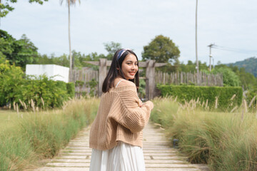 Beautiful asian woman in casual clothes walk in the garden on weekend