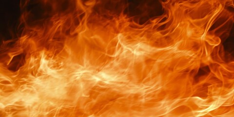 Fototapeta premium close-up of the flames, capturing their intense heat and dynamic movement in orange tones. The background is dark to highlight the fire's glow