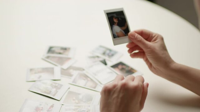 Hands Holding Instant Photos as Memories