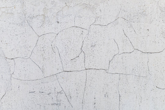 Light cracked wall. Minimalistic soft wall texture with cracked details.