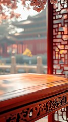 Wooden table illuminated by soft sunlight in a traditional setting with red structures and greenery in the background