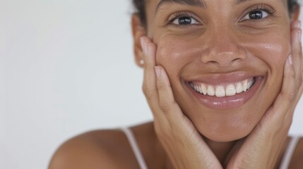 "A woman in a selfie shows off her glowing skin after using skincare products."